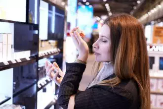beautiful girl chooses perfume in a cosmetic store