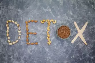 Detox diet. Word detox is made from nuts, flax seeds and wooden knives